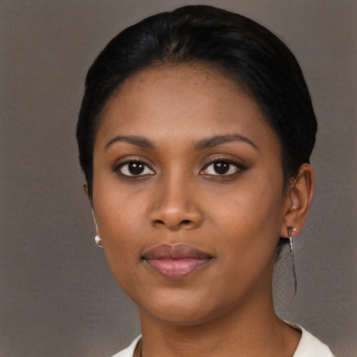 Joyful black young-adult female with short  black hair and brown eyes