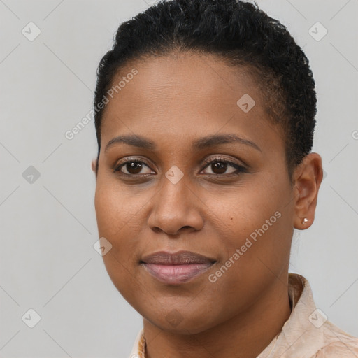 Joyful black young-adult female with short  brown hair and brown eyes