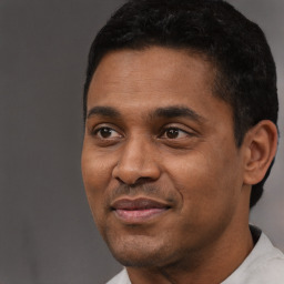 Joyful black adult male with short  black hair and brown eyes