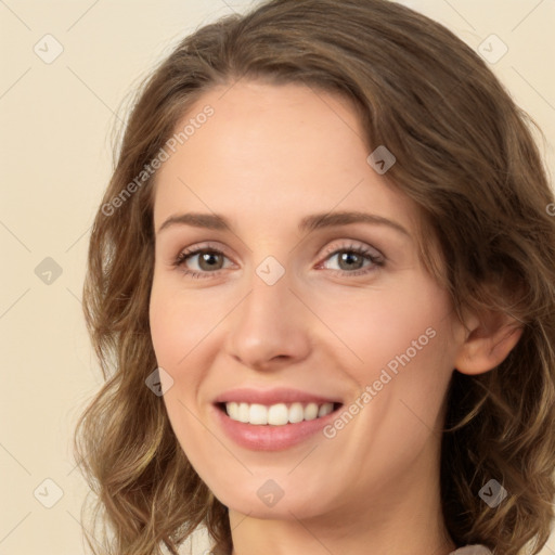 Joyful white young-adult female with long  brown hair and green eyes