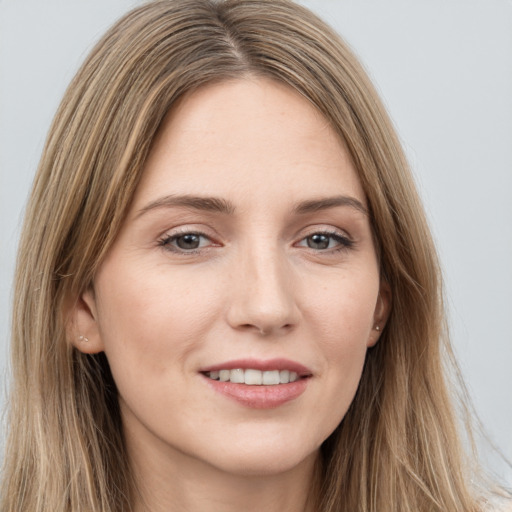 Joyful white young-adult female with long  brown hair and grey eyes