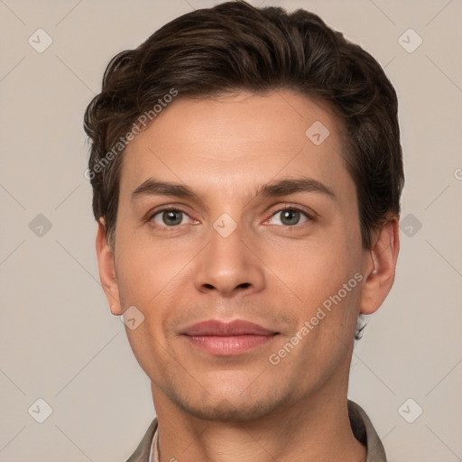 Joyful white young-adult male with short  brown hair and grey eyes