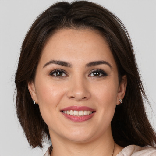 Joyful white young-adult female with medium  brown hair and brown eyes