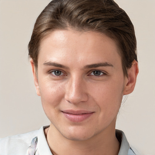 Joyful white young-adult female with short  brown hair and grey eyes