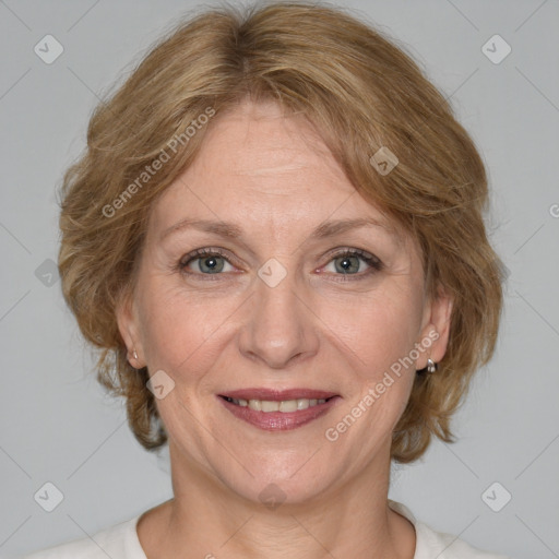 Joyful white adult female with medium  brown hair and blue eyes