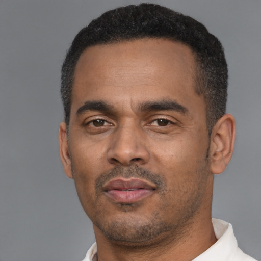 Neutral latino adult male with short  black hair and brown eyes
