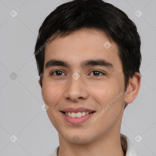 Joyful white young-adult male with short  black hair and brown eyes