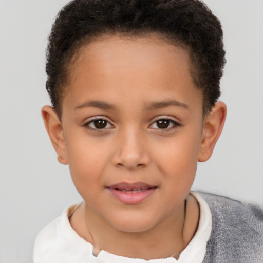 Joyful latino child female with short  brown hair and brown eyes