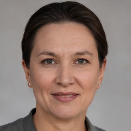 Joyful white adult female with medium  brown hair and brown eyes