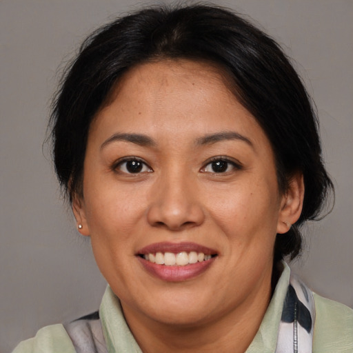 Joyful asian adult female with medium  brown hair and brown eyes
