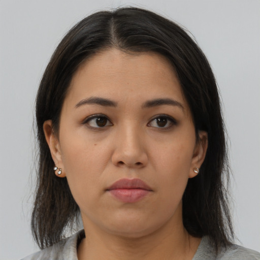 Neutral latino young-adult female with medium  brown hair and brown eyes