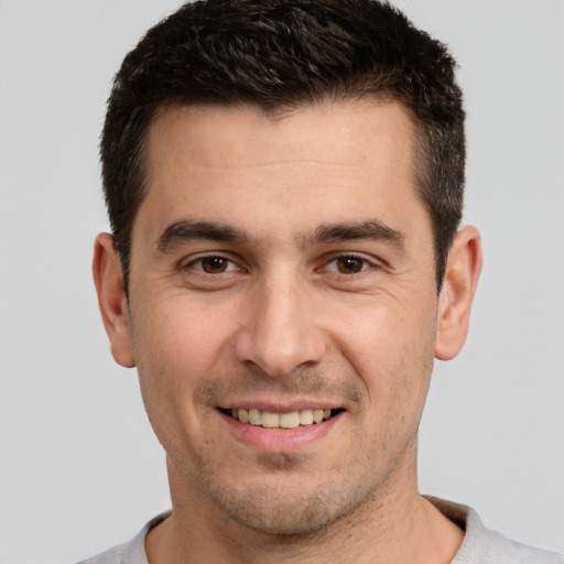 Joyful white young-adult male with short  brown hair and brown eyes