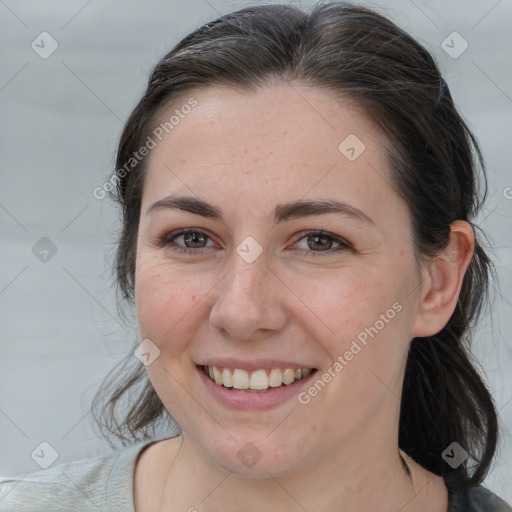 Joyful white young-adult female with medium  brown hair and grey eyes