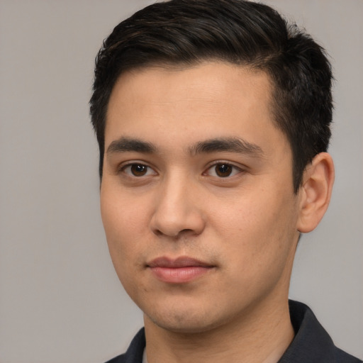 Joyful white young-adult male with short  black hair and brown eyes