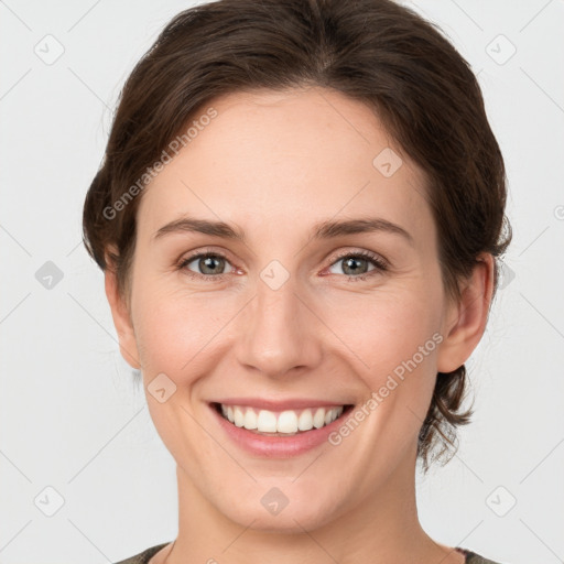 Joyful white young-adult female with medium  brown hair and grey eyes