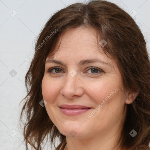 Joyful white adult female with long  brown hair and brown eyes