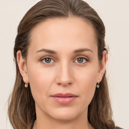 Joyful white young-adult female with long  brown hair and grey eyes