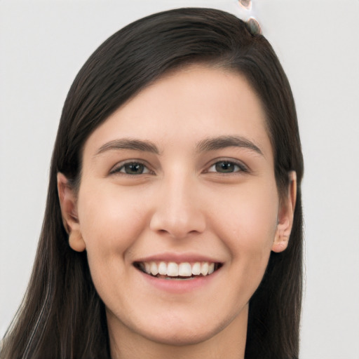 Joyful white young-adult female with long  brown hair and brown eyes