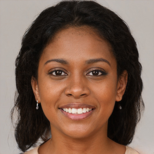Joyful black young-adult female with medium  brown hair and brown eyes