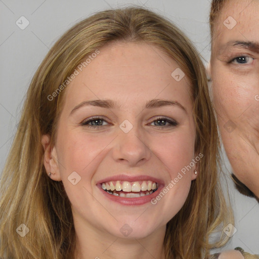 Joyful white young-adult female with long  brown hair and brown eyes