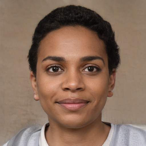 Joyful black young-adult female with short  black hair and brown eyes