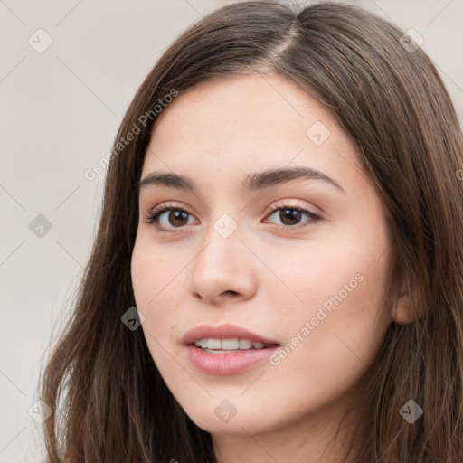 Neutral white young-adult female with long  brown hair and brown eyes