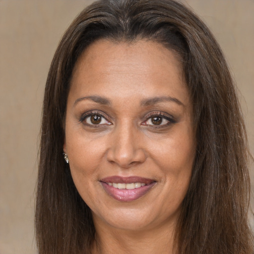 Joyful white adult female with long  brown hair and brown eyes