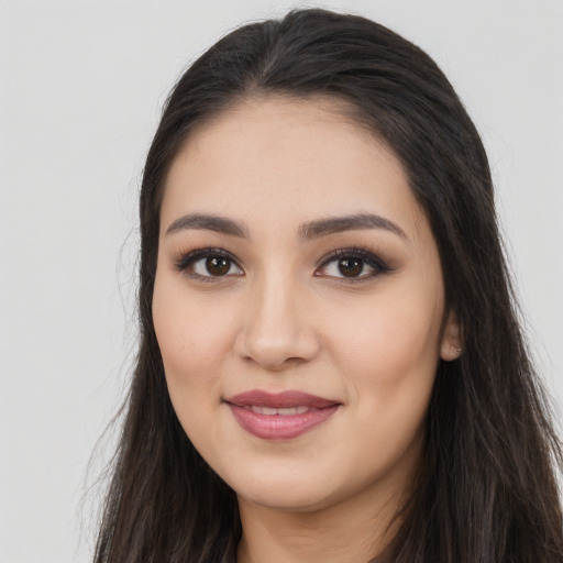 Joyful latino young-adult female with long  black hair and brown eyes