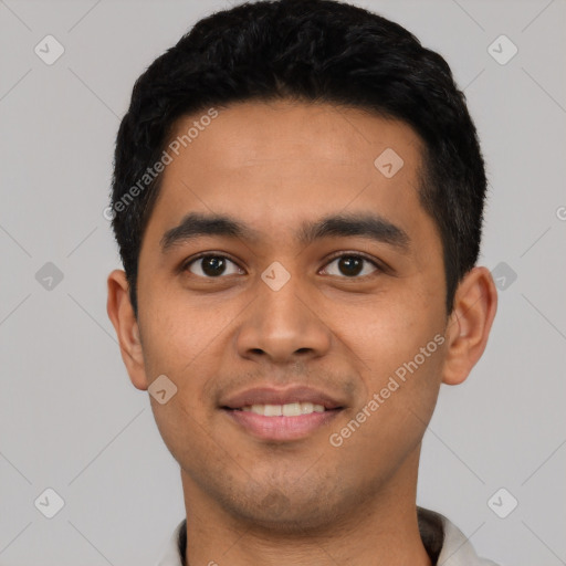 Joyful latino young-adult male with short  black hair and brown eyes