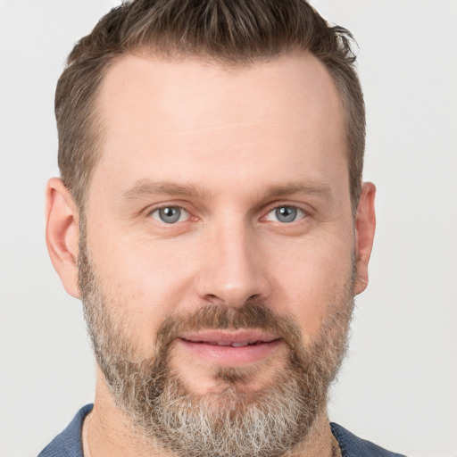 Joyful white adult male with short  brown hair and grey eyes