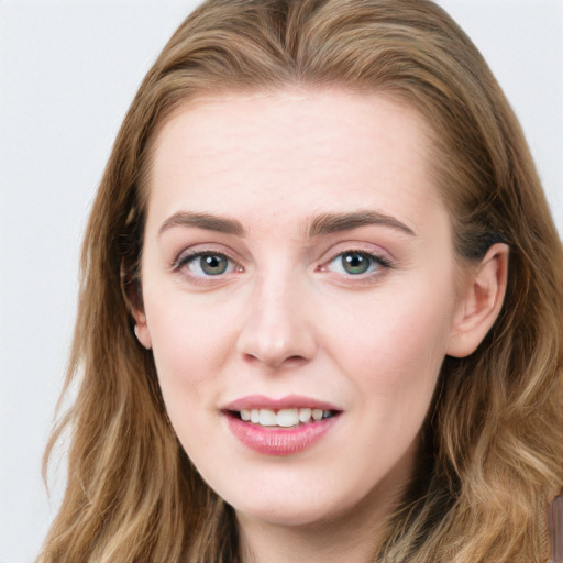 Joyful white young-adult female with long  brown hair and blue eyes