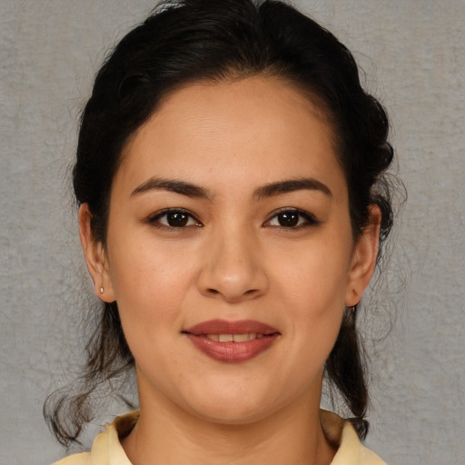 Joyful latino young-adult female with medium  brown hair and brown eyes