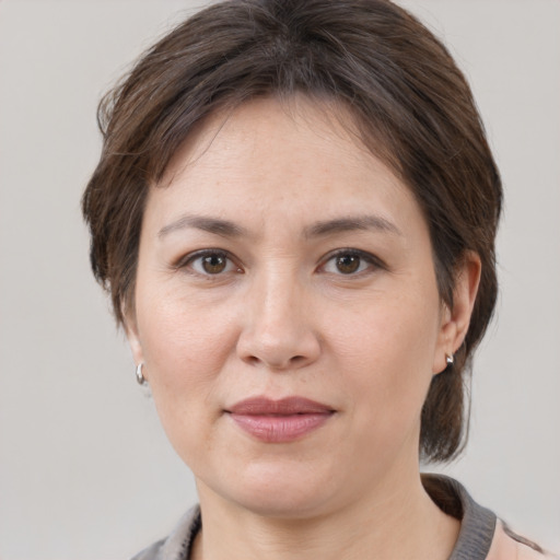 Joyful white adult female with medium  brown hair and brown eyes