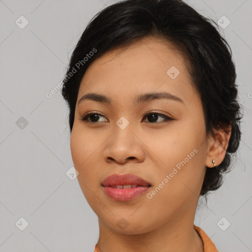 Joyful asian young-adult female with medium  black hair and brown eyes