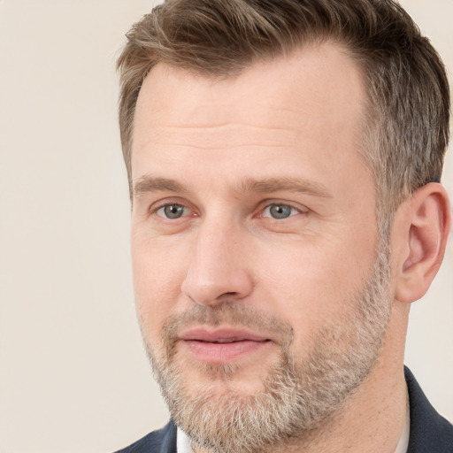 Joyful white adult male with short  brown hair and grey eyes