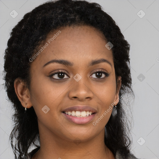 Joyful black young-adult female with long  black hair and brown eyes