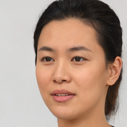 Joyful asian young-adult female with medium  brown hair and brown eyes