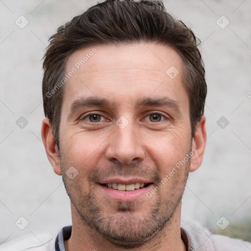 Joyful white adult male with short  brown hair and brown eyes