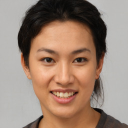 Joyful asian young-adult female with short  brown hair and brown eyes