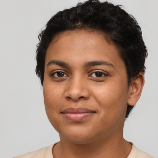 Joyful latino young-adult female with short  brown hair and brown eyes