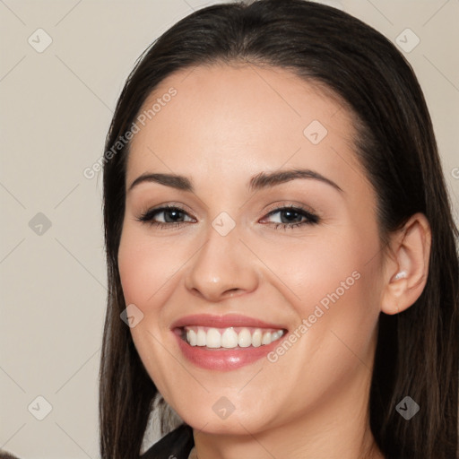 Joyful white young-adult female with long  black hair and brown eyes