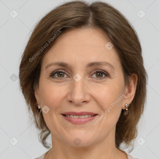 Joyful white adult female with medium  brown hair and brown eyes