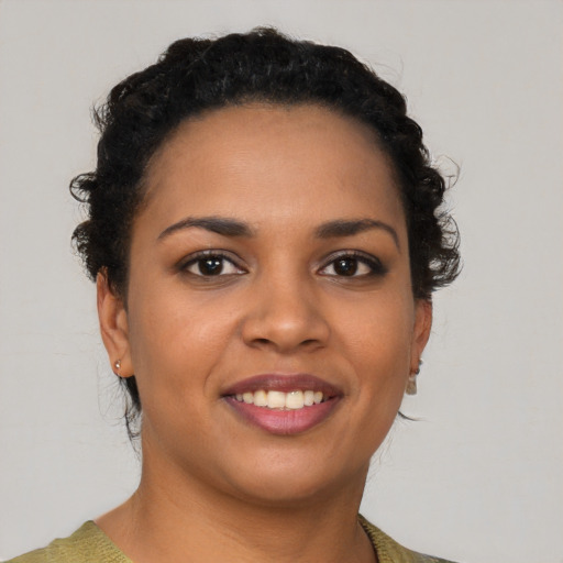 Joyful latino young-adult female with short  black hair and brown eyes