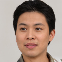 Joyful asian young-adult male with short  brown hair and brown eyes