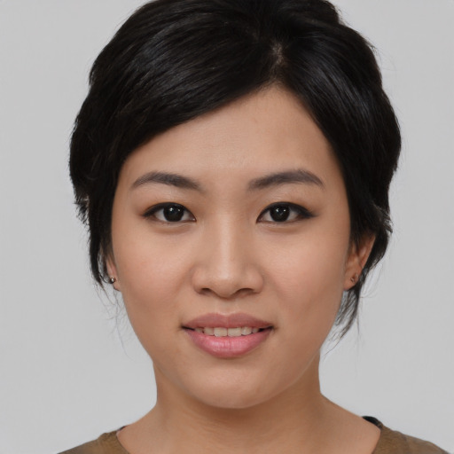 Joyful asian young-adult female with medium  black hair and brown eyes