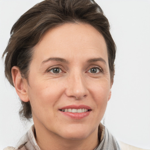 Joyful white adult female with medium  brown hair and grey eyes