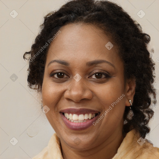 Joyful black adult female with medium  brown hair and brown eyes