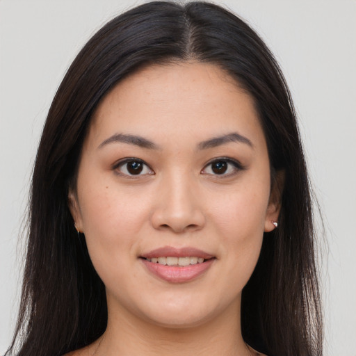 Joyful asian young-adult female with long  brown hair and brown eyes