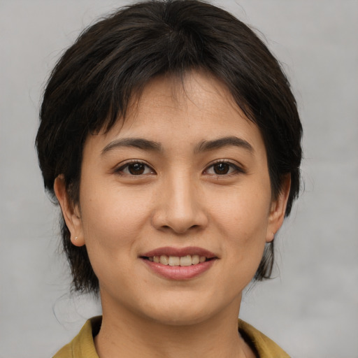 Joyful asian young-adult female with medium  brown hair and brown eyes