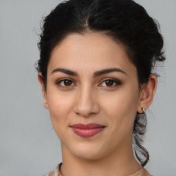 Joyful latino young-adult female with medium  brown hair and brown eyes